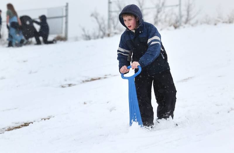 John Sutter, 12, from DeKalb, cruises down the DeKalb Park District sled hill Wednesday, Jan. 25, 2023, at Hopkins Park in DeKalb.