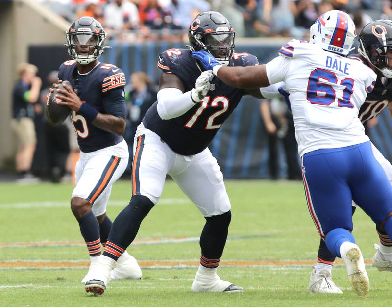 Chicago Bears quarterback PJ Walker looks for a receiver as he is protected by offensive tackle Alex Leatherwood during their game against the Buffalo Bills Saturday, Aug. 26, 2023, at Soldier Field in Chicago.
