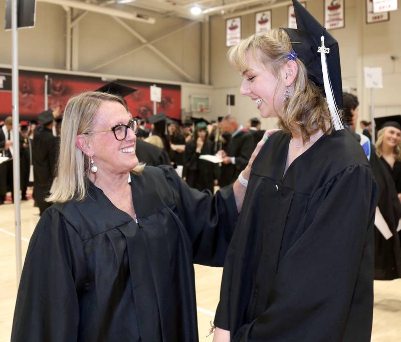 Kaneland teacher Candy Soper chats with her former kindergartner, Emilee Schultz before the Kaneland High School Class of 2023 Graduation Ceremony on Sunday, May 21, 2023 in DeKalb.