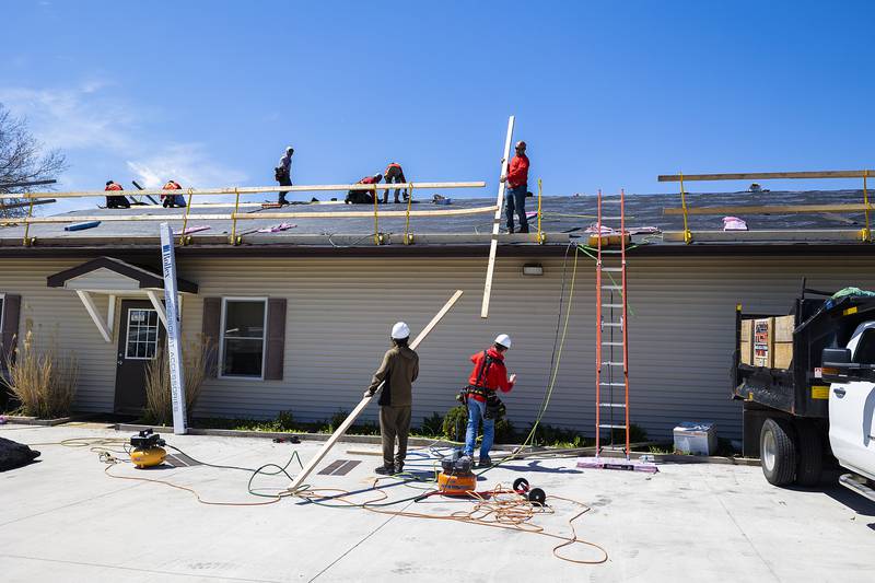 TCS, Total Construction Services of Sterling, work on the roof of the Twin Cities Homeless Shelter on Friday, April 19, 2024 in Sterling.