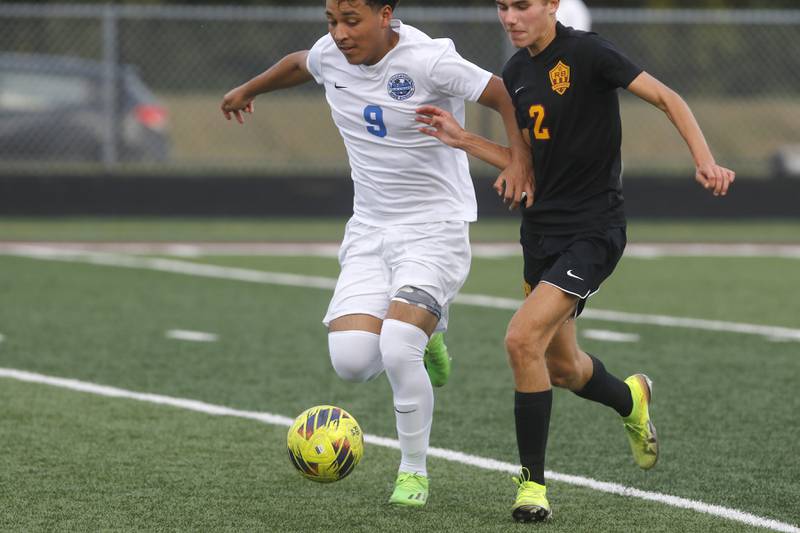 Woodstock's Eric Jacinto tries to control the ball in front of Richmond-Burton’s  William Gardner during a Kishwaukee River Conference soccer match on Wednesday, Sept. 10, 2025, at Richmond-Burton High School, in Richmond.