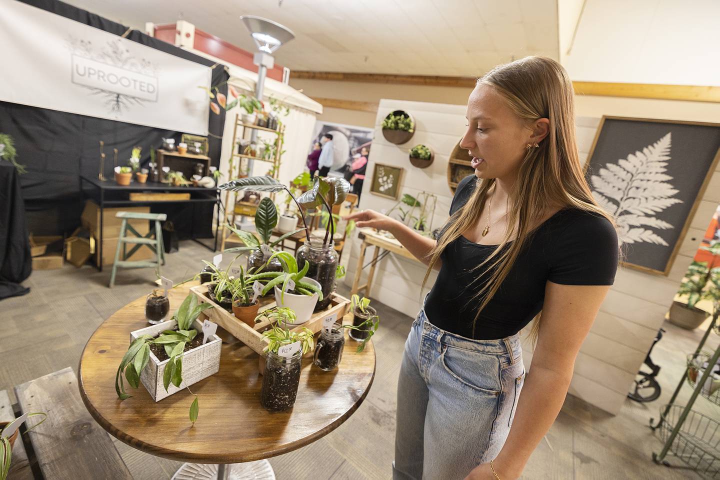 “Uprooted” business owner Makenzie Toms of Dixon High School talks about how her plants and pots are up cycled from other growers Wednesday, April 24, 2024 at the WACC CEO trade show.