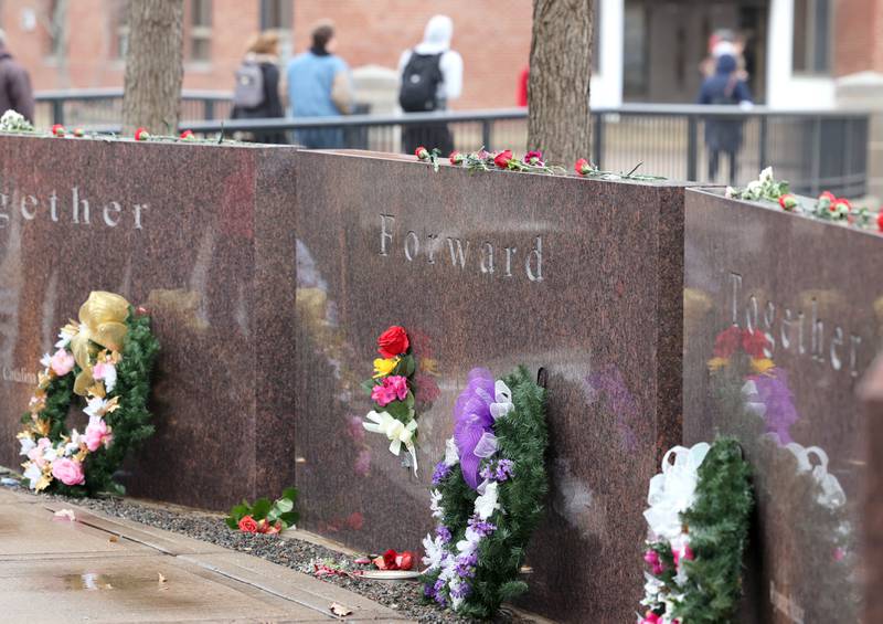 Shaw Local file photo – Flowers lay placed on Northern Illinois University's Forward, Together Forward memorial on Tuesday, Feb. 14, 2023, after an annual remembrance ceremony outside Cole Hall for the five victims of a Feb. 14, 2008, mass shooting.