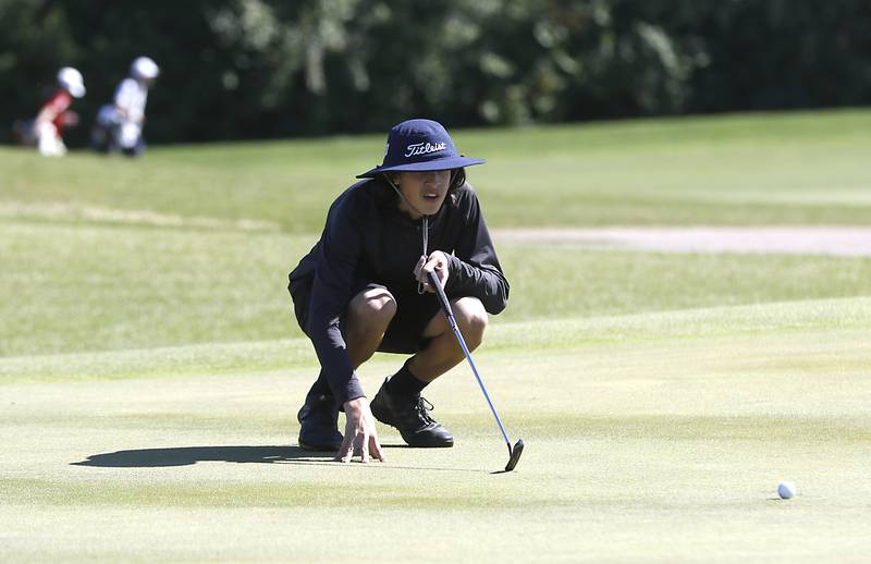 Woodstock North’s Alexander Treadway lines up his putt on the seventh green during the IHSA Boys’ Class 3A Sectional Golf Tournament Monday, Oct. 3 2022, at Randall Oaks Golf Club in West Dundee.