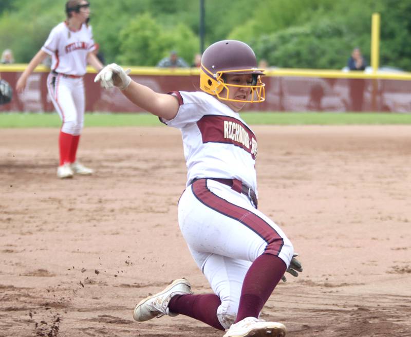 Richmond-Burton’s Sydney Hird slides safely into third base against Stillman Valley in softball sectional title game action in Richmond Friday evening.