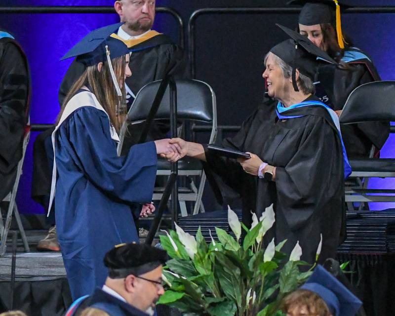 Oswego East senior Oliva Strickland receives her diploma on Saturday May 17, 2025, during the graduation ceremony held at the Convocation Center in DeKalb.