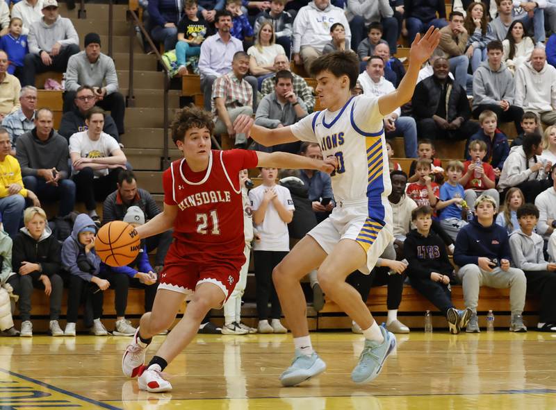 Hinsdale Central's Justin Kurkowski (21) looks for an outlet during a varsity basketball game between Hinsdale Central and Lyons Township high schools on Friday, Dec. 12, 2025 in La Grange.