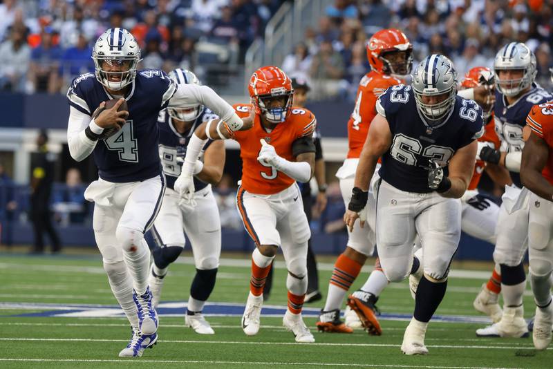 Dallas Cowboys quarterback Dak Prescott runs for a first down during the first half against the Chicago Bears, Sunday, Oct. 30, 2022, in Arlington, Texas.