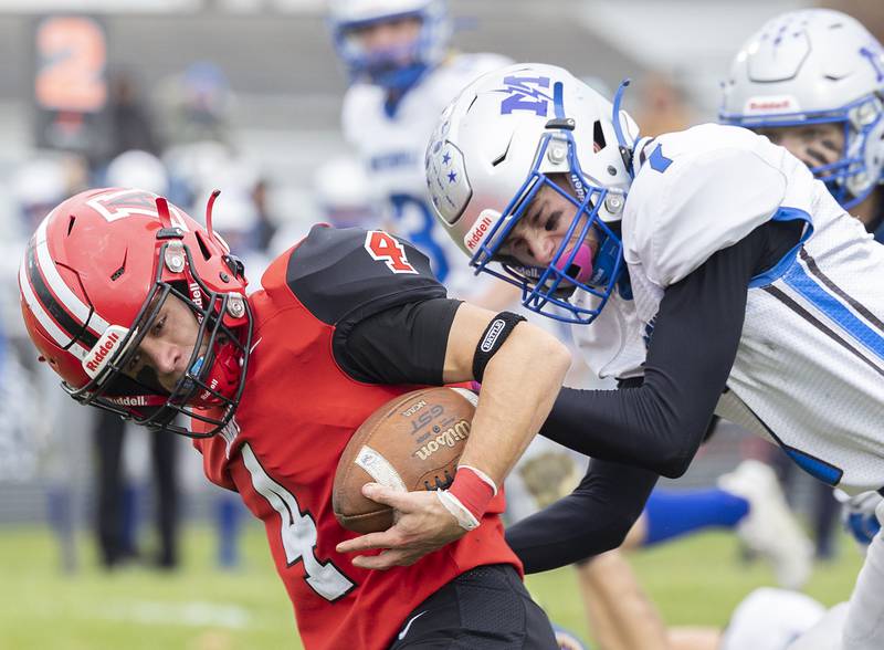 Amboy’s Josh McKendry is tackled by Martinsville’s Evan Seaman Saturday, Nov. 9, 2024, in round two of the 8-man football playoffs.