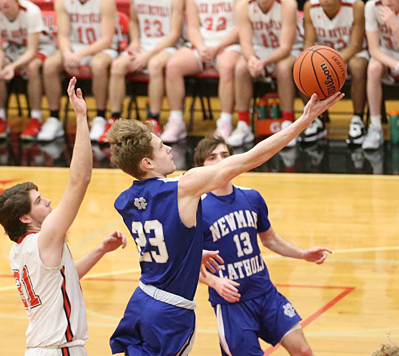 Newman's George Jungerman runs into the lane to score a basket over Hall's Hunter Meagher on Friday, Feb. 3, 2023 at Hall High School.
