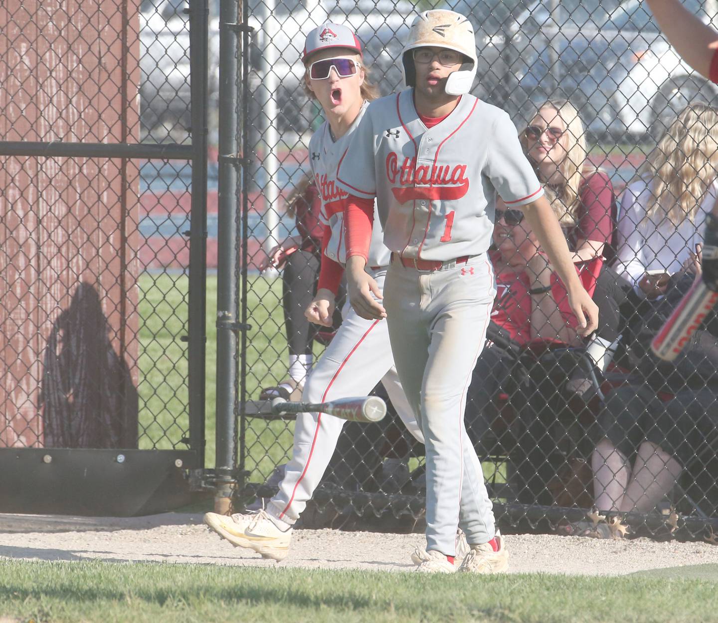 Ottawa's Hudson Hart reacts with teammate Julian Alexander after scoring the teams first run during the Class 3A Regional semifinal game on Thursday, May 25, 2023 at Morris High School.