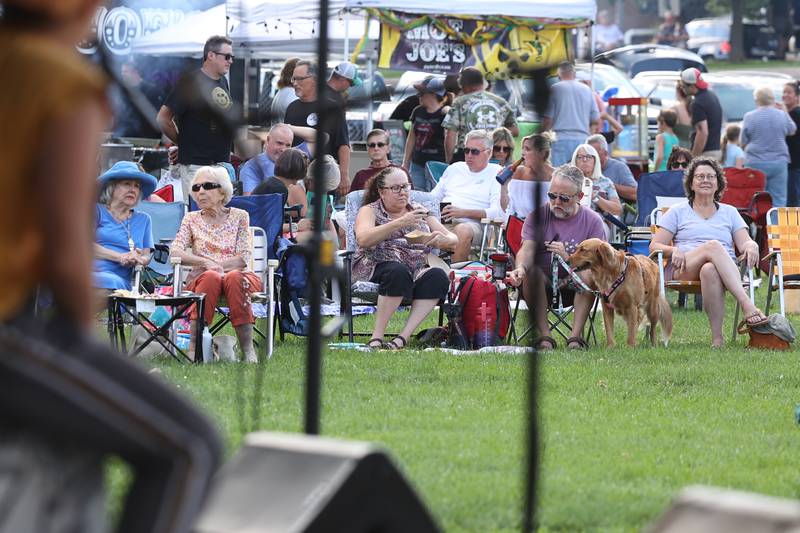 Event goers take in the music of i.am.james and Lebo at the evening concert at Preservation Park. The Upper Bluff Historic District hosted Porch & Park Music Fest featuring a variety of musical artist at five different locations. Saturday, July 30, 2022 in Joliet.