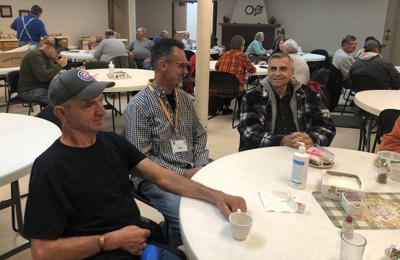 Claus Albrecht, Pastor Howard "Doc" Newcomb and Tom Flaherty chat on Tuesday, Oct. 18,  2022, at Marengo's Stone Soup Social. The weekly meal and food pantry moved to the United Methodist Church earlier this month.
