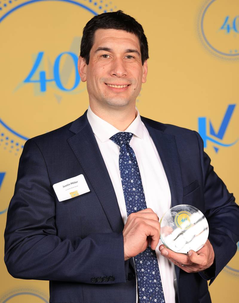 Jason Miller poses with his 40 Under Forty award during the Illinois Valley Chamber of Commerce Champions of Change Awards Night on Thursday, April 10, 2025 at the Westclox Event Center in Peru.
