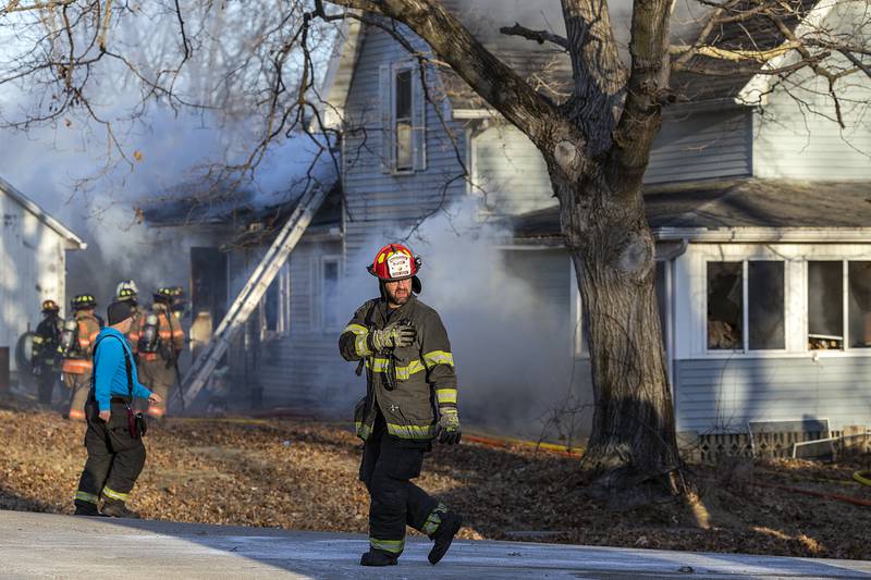 Firefighters pour water onto a fire Sunday, Jan. 19, 2025, at 550 Mill Street in Emerson.