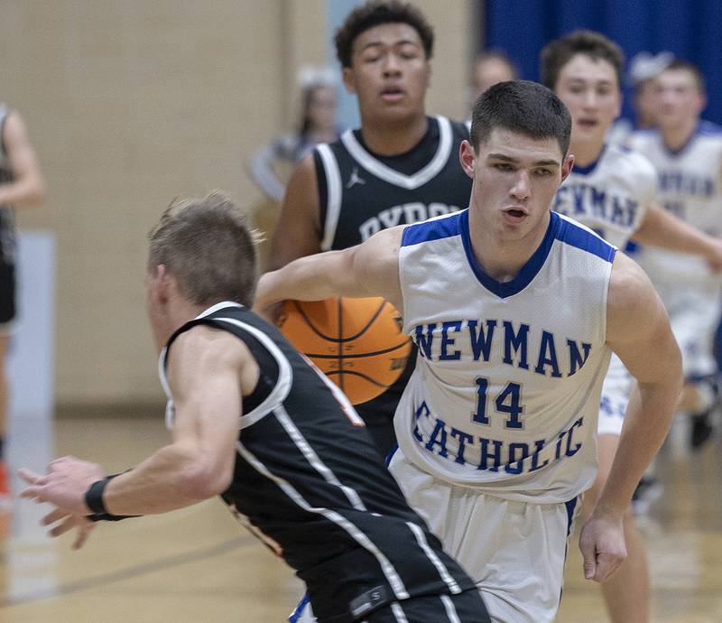 Newman’s Renner Rosengren handles the ball against Byron’s JJ Edmonson Tuesday, Dec. 3, 2024, at Newman High School.