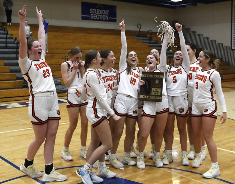 Crystal Lake Central players celebrate defeating Burlington Central to win the IHSA Class 3A Woodstock Regional Championship girls basketball game on Thursday, Feb. 15, 2024, at Woodstock High School.