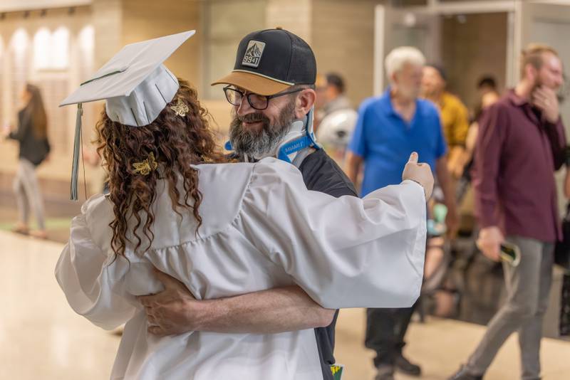 David Smith is one of the first to find and hug his daughter Kaylin in the hallway to celebrate her graduation after the Seneca High School Class of 2026 Graduation on May 17, 2026 at Seneca High School.