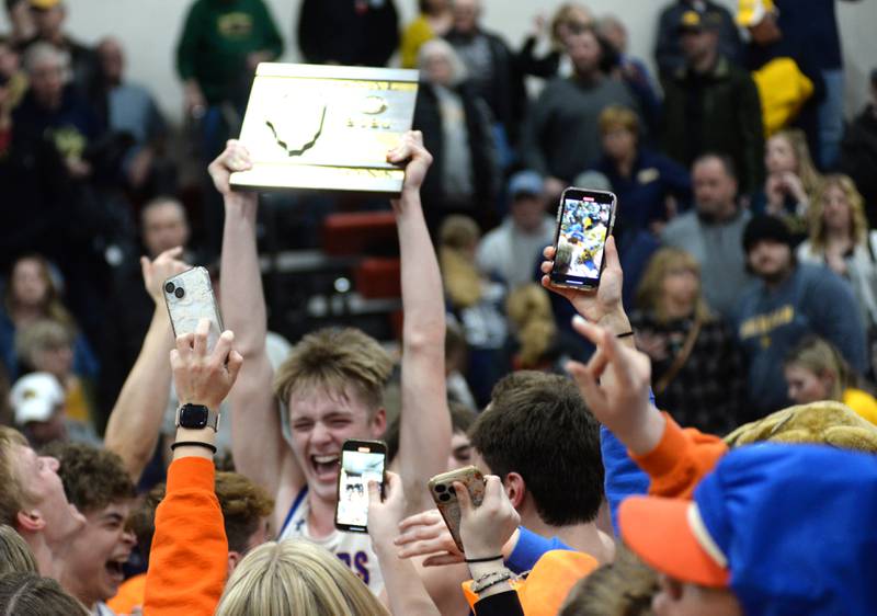 Eastland's Trevor Janssen (11 a senior holds the regional trophy as the Cougars celebrate after beating Polo on Friday, Feb. 23, 2024 to win the 1A Forreston Regional championship held at Forreston High School.