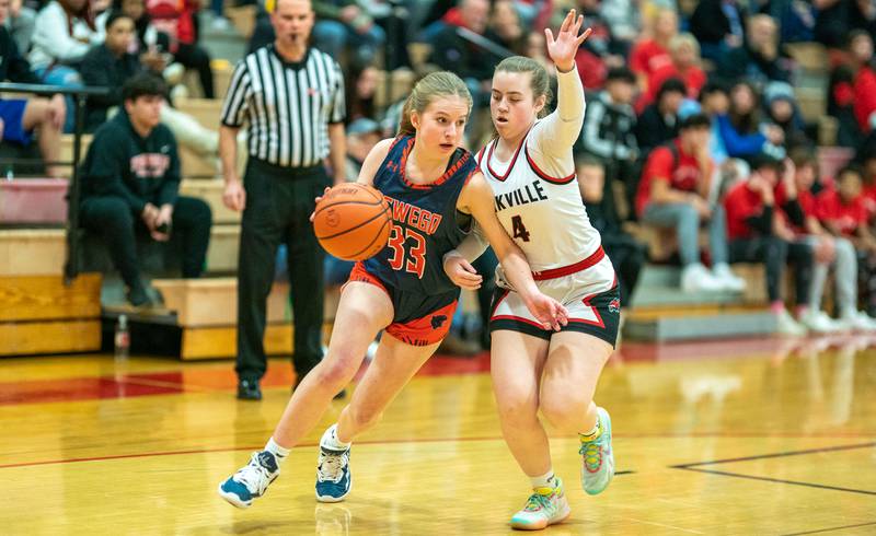 Oswego’s Ashley Cook (33) drives the baseline against Yorkville's Abigail Pool (4) during the 13th annual Hoops 4 Hope Communities vs. Cancer basketball event at Yorkville High School on Saturday, Jan 28, 2023.