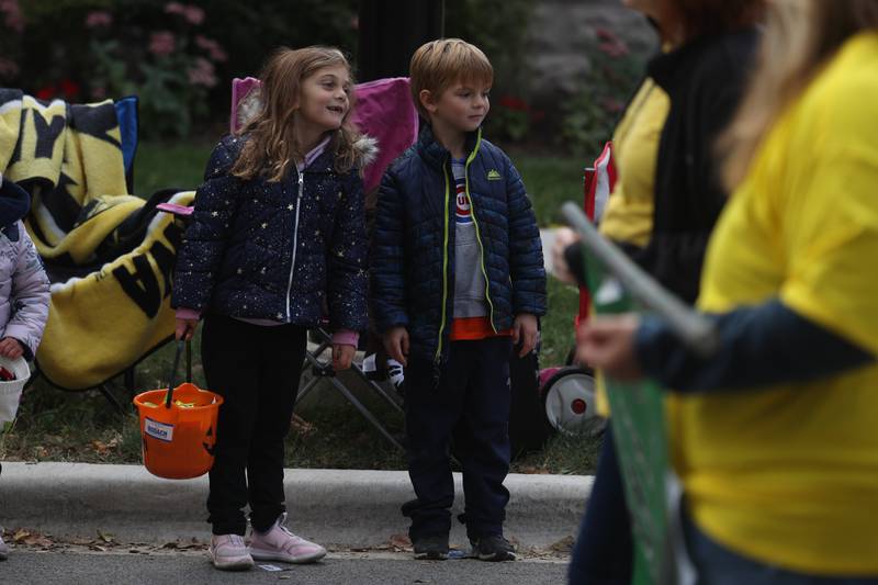 Madison Drescher, 6, and Will Esbrook, 6, watch the 70th Annual Plainfield Homecoming Parade. Saturday, Oct. 8, 2022, in Plainfield.