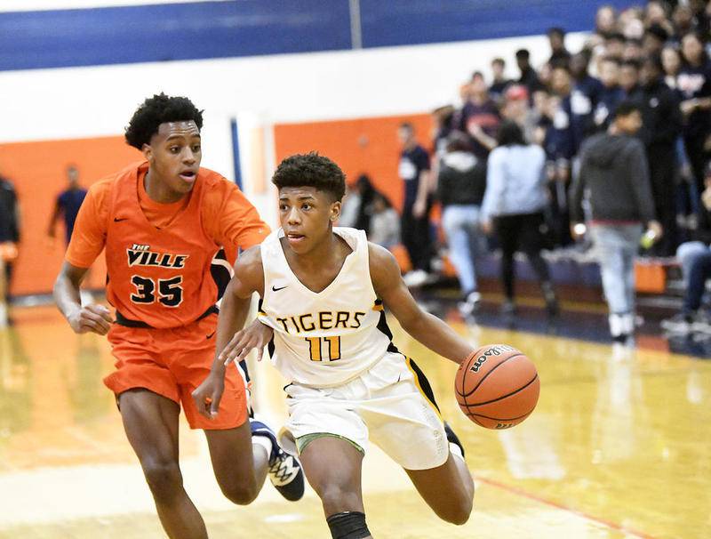 Joliet West’s Jeremy Fears Jr. drives to the basket in front of Romeoville’s Tyler Johnson on Friday, March, 6, 2020.