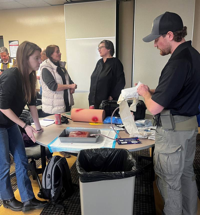 Kane County Sheriff's Deputy Detective Jeremy Jorgensen, (far right) demonstrates a pressure bandage to stop a life-threatening bleed at the Regional Office of Education's Teachers' Institute Day. The Sheriff's Office and Health Department held 19 free training sessions in February for Cardiopulmonary Resuscitation  and Stop the Bleed. They trined 471 people in lifesaving procedures.