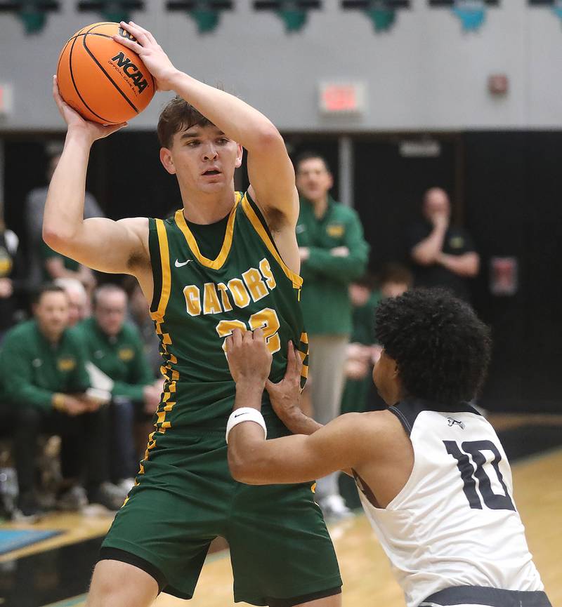 Crystal Lake South's David Mcfadden looks to pass as he is guarded by Kaneland's Jalen Carter during the IHSA Class 3A Woodstock North Sectional final basketball game on Friday, March 6, 2026, at Woodstock North High School.