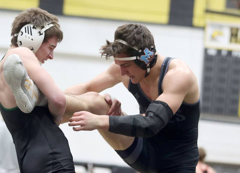 Marian’s Nic Astacio, right, battles Crystal Lake South’s Aiden Marrello at 165 pounds in boys wrestling IHSA Class 2A Regional championship bout action on Saturday, Jan. 31, 2026, at Harvard High School in Harvard.