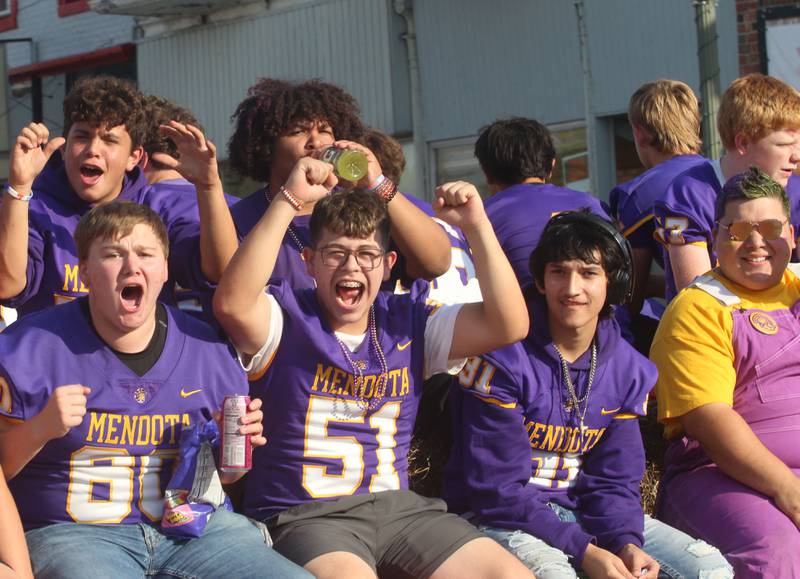 Members of the Mendota High School football team ride down Indiana Avenue during the homecoming parade on Friday, Oct. 3, 2025