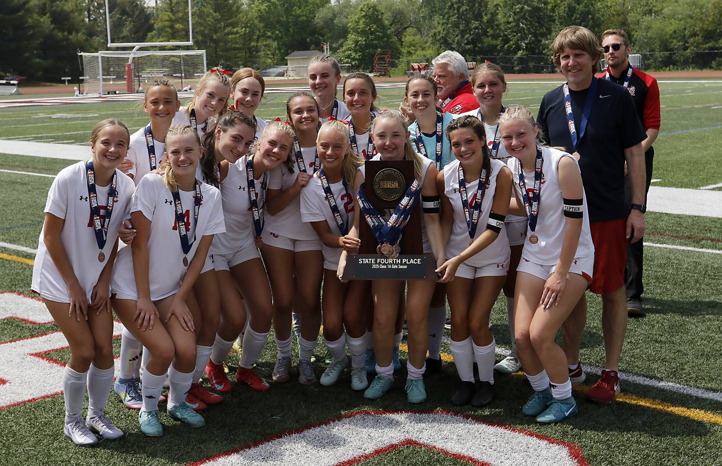 Timothy Christian players with their four place trophy after the IHSA Class 1A State Girls Soccer third-place match against Williamsville on Friday, June 6, 2025, at North Central College in Naperville.