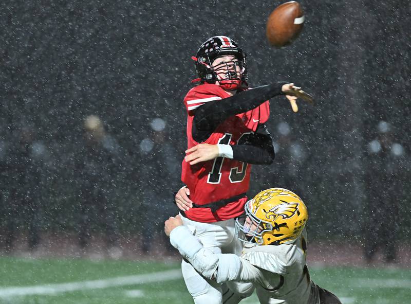 Lincoln-Way Central's Michael Kuehl tries the throw the ball under pressure during the class 7A first round  playoff game on Friday, Oct. 27, 2023, at New Lenox. (Dean Reid for Shaw Local News Network)