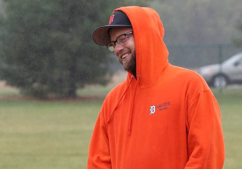 Matt Quinto, U.S. Navy veteran and DeKalb High School football coach, manages a smile despite the rain during practice Tuesday, Sept. 24, 2024, at DeKalb High School.