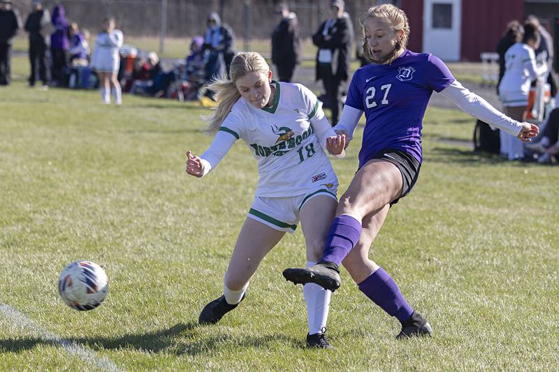 Dixon’s Makenzie Toms makes a pass while being guarded by North Boone’s Gracie Swenson Thursday, April 6, 2023.