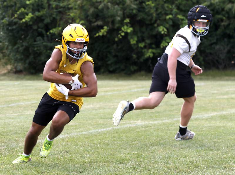 Jacobs’ Justin Gonzalez runs with the football during football practice on Tuesday, August 15, 2025, at Jacobs High School in Algonquin.