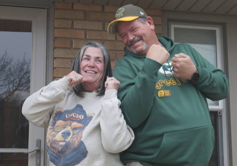 Denise and Jeff King of Peru, display their Chicago Bears and Green Bay Packerg gear outside their home on Tuesday, Jan. 6, 2026 in Peru. The couple have been lifeling fans while living in a house divided. The Bears will play the Packers in the playoffs for the third time ever this Saturday in the NFC Wildcard game at 7p.m. on Amazon Prime.