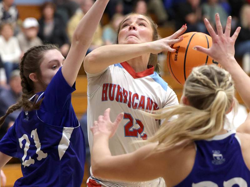 Marian Central's Jenna Remke gets to the basket between Hinckley-Big Rock's Matilda Simon (left) and Hinckley-Big Rock's Anna Herrmann Monday, Feb. 16, 2026, during their regional semifinal game at Hinckley-Big Rock High School.