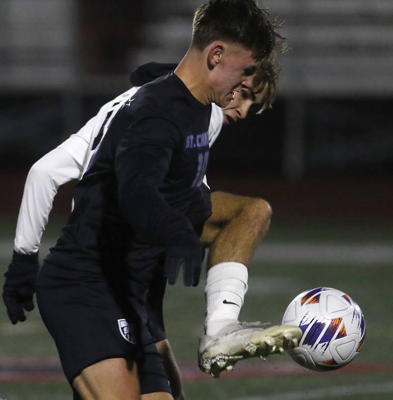 McHenry's Kyren Rivard kicks the ball away from St. Charles North's Oliver Longoszin during an IHSA Class 3A Huntley Regional boys soccer semifinal match on Tuesday, Oct. 21, 2025, at Huntley High School.