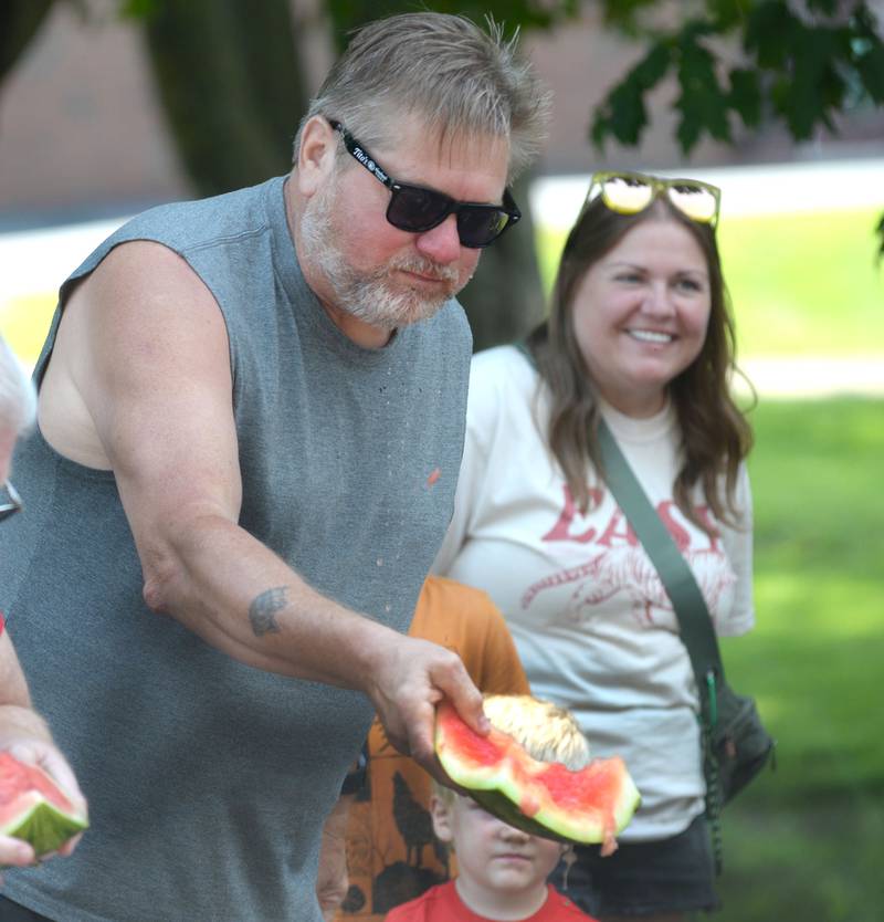 David Coy of Milledgeville (right) shows his rind to the judge to win the adult division at Sauerkraut Days' watermelon-eating contest in Forreston on Saturday, Aug. 2, 2025.