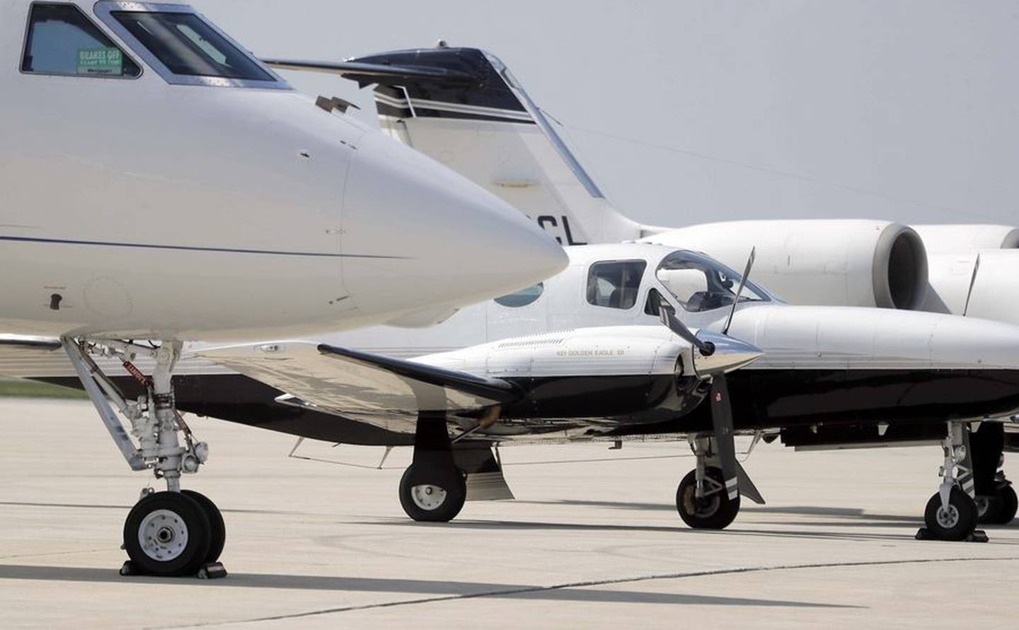Airplanes line up at the DuPage Airport during a busy day in West Chicago.