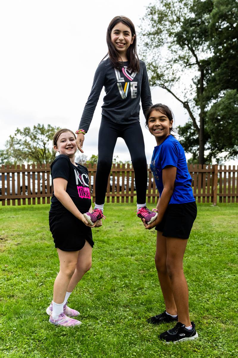 Lemont residents Mairead Baxter, Penelope Hernandez, and Alexandra Hernandez enjoy the green space at the Slovenian Grape Harvest Festival on Sept. 29, 2024.