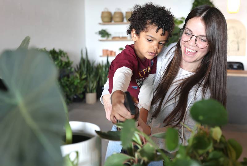 Kailey Rorer, owner of The Greenhouse, 265 W. Peace Road in Sycamore, gets some help from her son T.J., 4, spraying the plants Tuesday, April 19, 2022, at the store. The Greenhouse will celebrate its grand opening on Saturday, April 23. The store will sell houseplants, plant stands, pots, and other giftable items. The Greenhouse is owned by Kailey and Troy Rorer of Sycamore. Business hours are 10 a.m. to 5 p.m. Wednesdays through Fridays, 10 a.m. to 4 p.m. Saturdays and 10 a.m. to 2 p.m. Sundays.