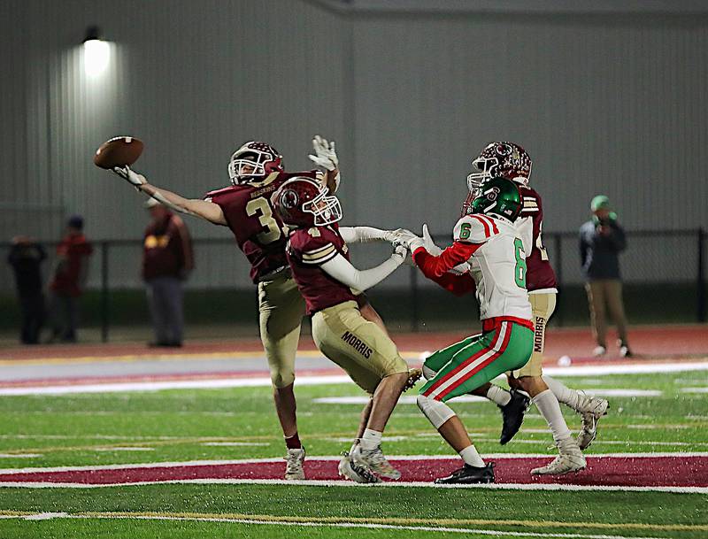 Morris' A.J. Zweeres (left) hauls in one of his two interceptions Friday night in a 42-0 win over LaSalle-Peru in the first round of the Class 5A playoffs.