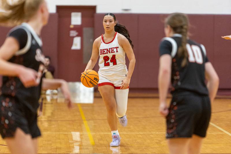 Benet's Emma Briggs dribbles the ball up court against St. Charles East at the Montini Christmas Tournament on Tuesday, Dec.23,2025 in Lombard.