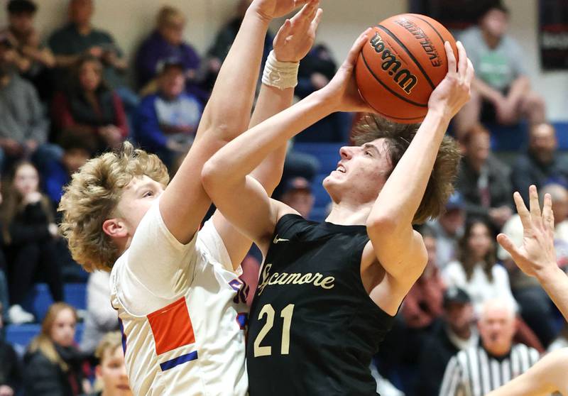 Sycamore's Ben Larry shoots over Genoa-Kingston's Hayden Hodgson during their game Wednesday, Feb. 14, 2024, at Genoa-Kingston High School.