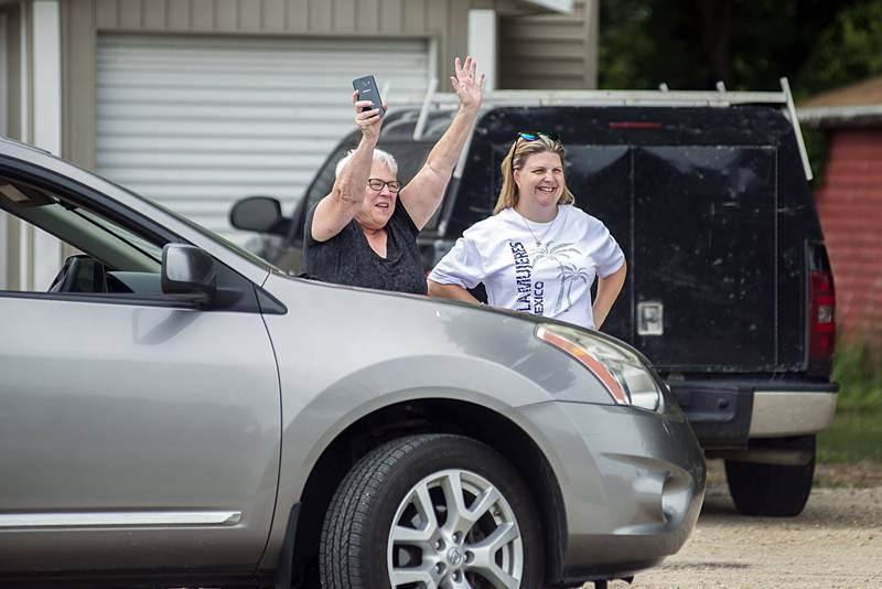 Parents and grandparents wave to their loved ones outside of Sterling Rock Falls Child Care Friday, July 1, 2022.