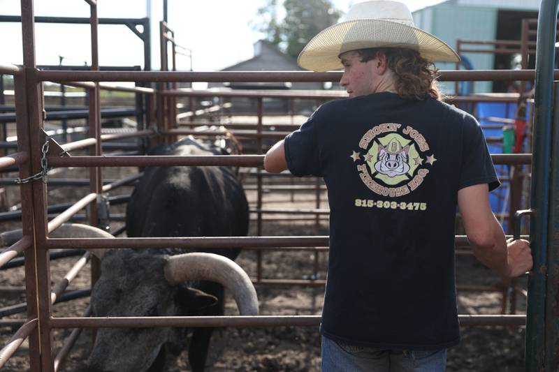 Dominic Dubberstine-Ellerbrock waits with one of the riding bulls at his weekly practice. Dominic will be competing in the 2022 National High School Finals Rodeo Bull Riding event on July 17th through the 23rd in Wyoming. Thursday, June 30, 2022 in Grand Ridge.