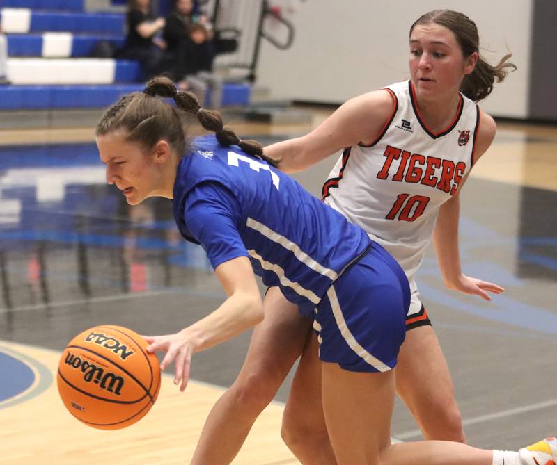 Burlington Central’s Julia Scheuer, left, gets past Crystal Lake Central’s Sammi Pottorff in IHSA Class 3A Regional Title Game girls basketball action on Thursday, Feb. 20, 2025, at  Central High School in Burlington.