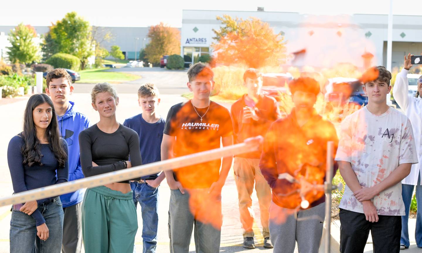 Students from St. Charles North High School watch as a ballon of hydrogen is ignited during an demonstration at Clarke Mosquito Control and Management in St. Charles during an industrial tour on Thursday, Oct 16, 2025.