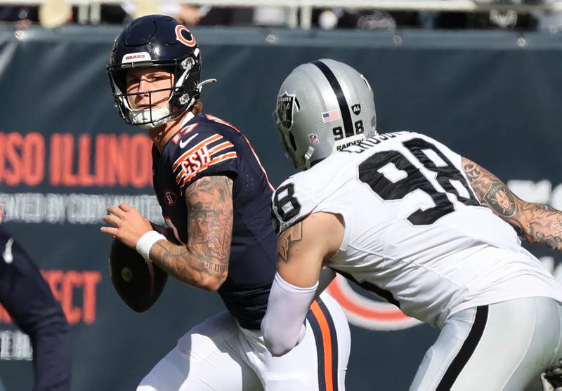 Chicago Bears quarterback Tyson Bagent scrambles out of the pocket to avoid the rush of Las Vegas Raiders defensive end Maxx Crosby during their game Sunday, Oct. 22, 2023, at Soldier Field in Chicago.